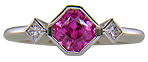 Pink Sapphire set with two Princess-cut diamonds in a platinum ring. (J8547)