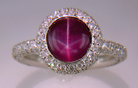 Plum Star Sapphire set with pave diamonds in a platinum ring.