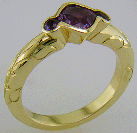 Cushion-cut Purple Sapphire with round Purple Sapphires in a custom platinum ring. (J8546)