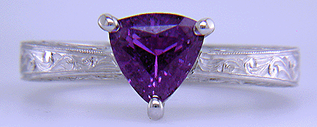 Hand engraved platinum ring with a trillium purple sapphire.