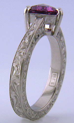 Hand engraved platinum ring with a trillium purple sapphire.