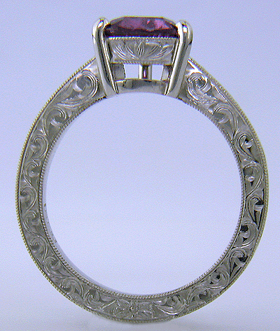 Side view of hand engraved platinum ring with a trillium purple sapphire.