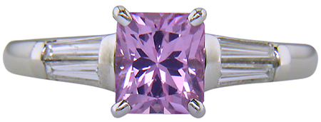 A radiant Pink Spinel set with tapered baguette diamonds in a custom platinum ring.