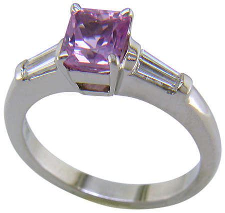 A radiant Pink Spinel set with tapered baguette diamonds in a custom platinum ring.