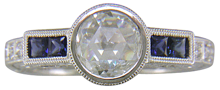 A Rose-cut Diamond set with Sapphires in a platinum ring. (J8749)