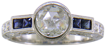 A Rose-cut Diamond set with Sapphires in a platinum ring.