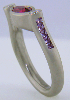 Hand-crafted platinum ring set with a Rubellite Tourmaline and diamonds. (J6651)