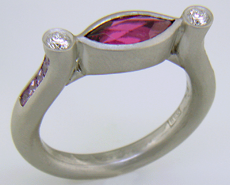 Hand-crafted platinum ring set with a Rubellite Tourmaline and diamonds. (J6651)