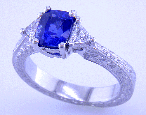 Sapphire ring with trilliant diamond and hand engraved platinum.