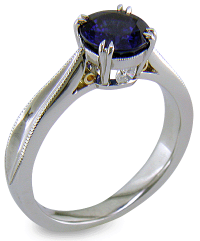 Sapphire ring handcrafted in platinum with two hidden diamonds and gold accents. (J8751)