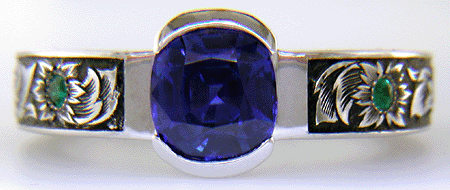 A cushion-cut Sapphire set in a beautifully hand crafted and engraved platinum ring.