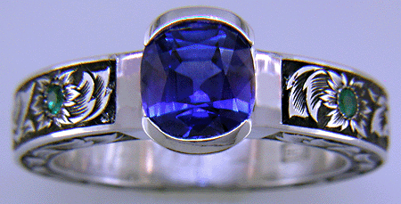 A cushion-cut Sapphire set in a beautifully hand crafted and engraved platinum ring.