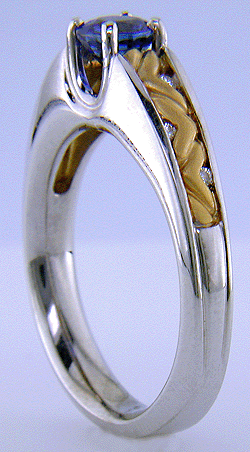 A blue sapphire set in an 18kt white gold ring with 22kt yellow gold shoulders.