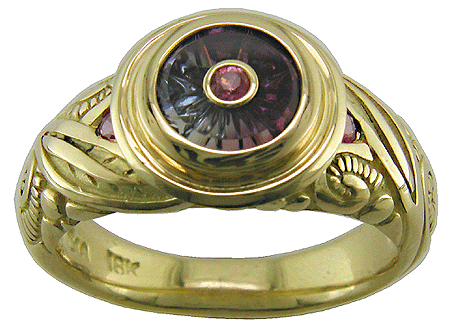 Torus-cut sapphire set in 18kt gold ring.