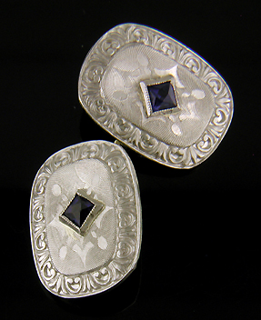 Elegantly engraved platinum and sapphire cufflinks. (J8973)