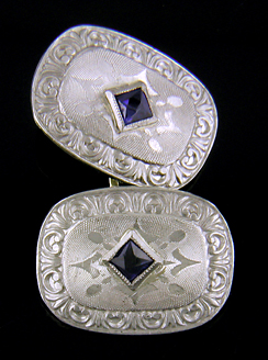 Elegantly engraved platinum and sapphire cufflinks. (J8973)