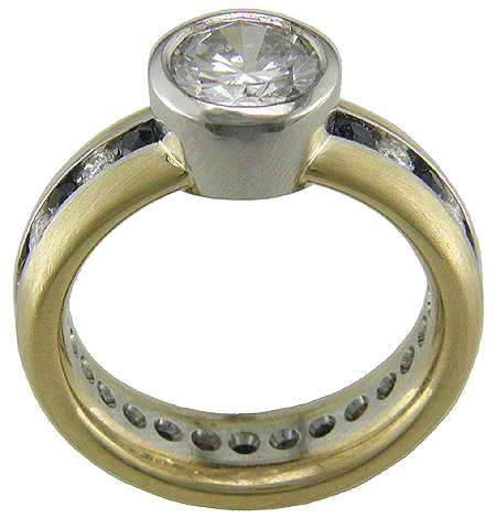 Side view of diamond and sapphire ring created in platinum and gold.