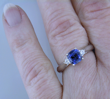 Square Cushion-cut Sapphire set with two round diamonds in a handcrafted platinum ring. (J8599)