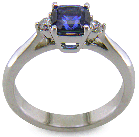 Square Cushion-cut Sapphire set with two round diamonds in a handcrafted platinum ring. (J8599)