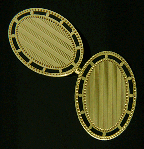 TH oval gold and black enamel cufflinks. (J8607)