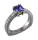 A tanzanite solitaire in a hand engraved platinum ring.