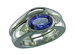 Platinum engagement ring featuring an oval tanzanite and trilliant fancy yellow diamonds with matching wedding band.
