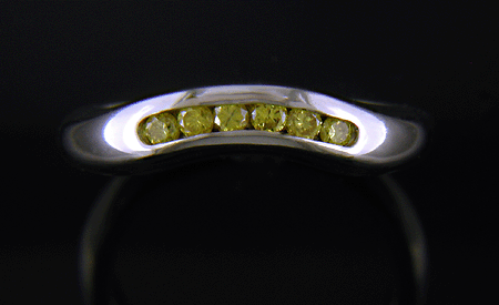 Contoured band with six small yellow diamonds.