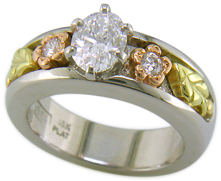 Custom platinum engagement ring with rose and green gold accents.