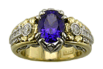 Tanzanite custom ring with diamonds handcrafted in platinum and gold.