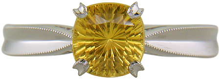 Concave faceted yellow sapphire set with two hidden diamonds in a handcrafted platinum ring. (J7253)