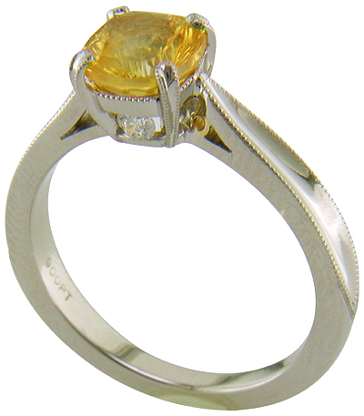 Concave faceted yellow sapphire set with two hidden diamonds in a handcrafted platinum ring. (J7253)