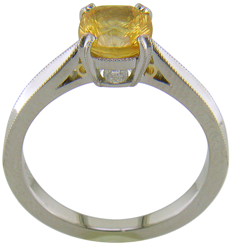 Side view of concave faceted yellow sapphire set with two hidden diamonds in a handcrafted platinum ring. (J7253)